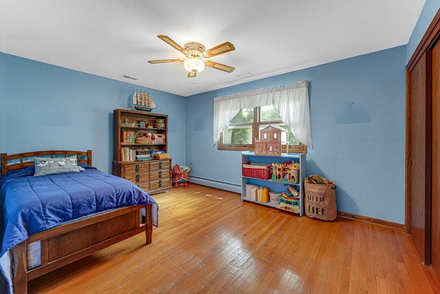 13007 S Oak Park Ave, Palos Heights, IL 60463 - bedroom featuring baseboard heating, light wood-type flooring, ceiling fan, and a closet