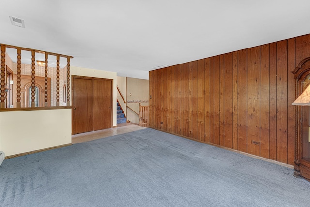 13007 S Oak Park Ave, Palos Heights, IL 60463 - carpeted empty room featuring wooden walls and stairway