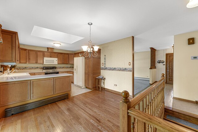 13007 S Oak Park Ave, Palos Heights, IL 60463 - kitchen with white appliances, a skylight, a baseboard heating unit, a chandelier, and light wood-style floors