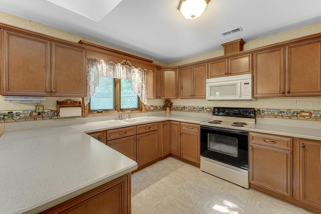 13007 S Oak Park Ave, Palos Heights, IL 60463 - kitchen featuring white microwave, electric stove, light countertops, and brown cabinetry