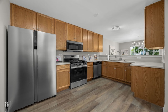 2416 Oakfield Dr Unit 2416, Aurora, IL 60503 - kitchen featuring stainless steel appliances, light wood-style floors, light countertops, and a chandelier