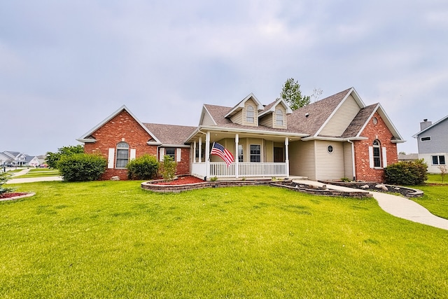 1102 Brian Dr, Manteno, IL 60950 - view of front of home with a porch, brick siding, a front lawn, and a shingled roof