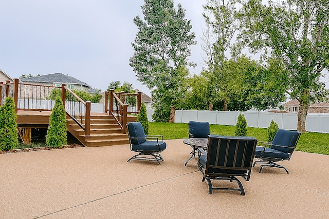 1102 Brian Dr, Manteno, IL 60950 - fenced backyard with stairs, a patio area, a wooden deck, and outdoor dining area