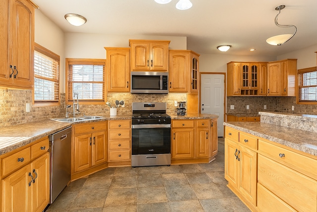 1102 Brian Dr, Manteno, IL 60950 - kitchen with stainless steel appliances, decorative backsplash, and glass insert cabinets