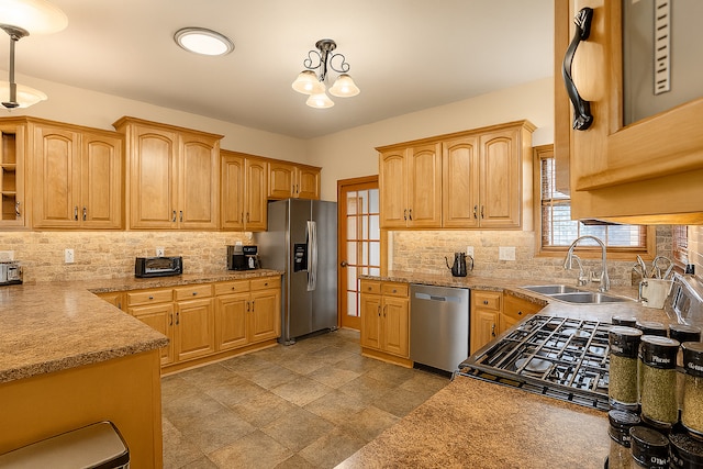 1102 Brian Dr, Manteno, IL 60950 - kitchen with appliances with stainless steel finishes, decorative light fixtures, and tasteful backsplash