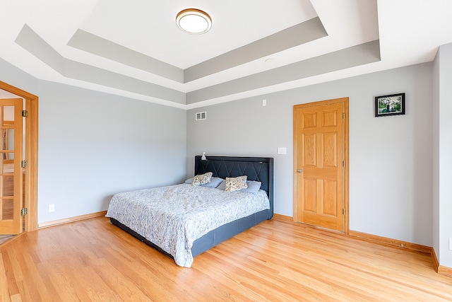 1102 Brian Dr, Manteno, IL 60950 - bedroom featuring a tray ceiling and wood finished floors