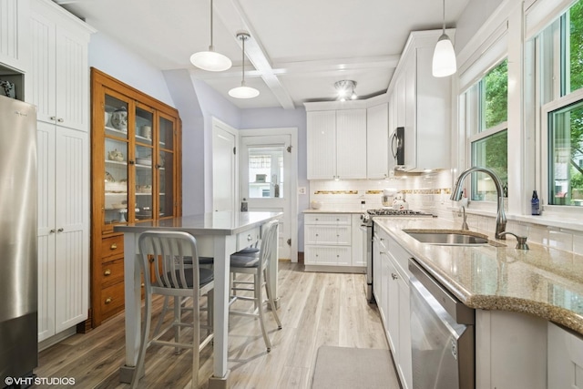 300 W Fremont St, Arlington Heights, IL 60004 - kitchen featuring stainless steel appliances, plenty of natural light, decorative backsplash, white cabinets, and coffered ceiling