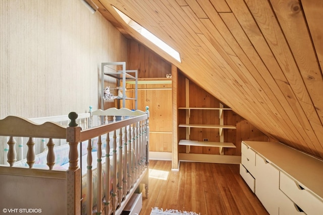 300 W Fremont St, Arlington Heights, IL 60004 - additional living space with vaulted ceiling, wood-type flooring, wooden walls, wood ceiling, and a skylight