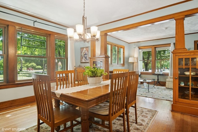 300 W Fremont St, Arlington Heights, IL 60004 - dining room featuring crown molding, a chandelier, light wood-style flooring, and decorative columns