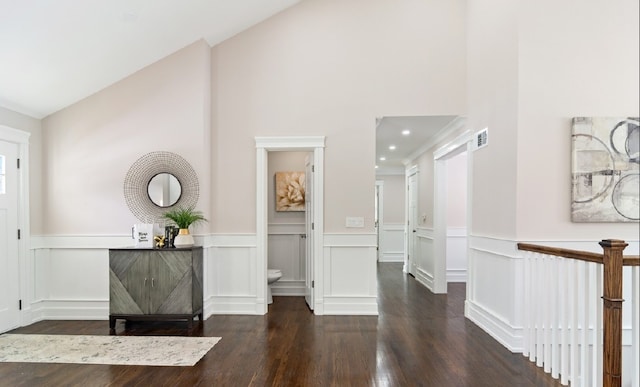 10701 Clearwater Way, Huntley, IL 60142 - hallway featuring wood finished floors, a wainscoted wall, a decorative wall, and high vaulted ceiling