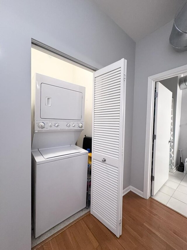 1200 W Monroe St Unit 516, Chicago, IL 60607 - laundry room with stacked washing machine and dryer and wood finished floors