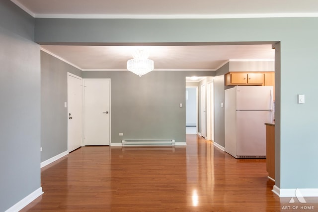 8049 Beloit Ave Unit 2C, Bridgeview, IL 60455 - spare room with baseboard heating, wood finished floors, ornamental molding, a baseboard radiator, and a chandelier