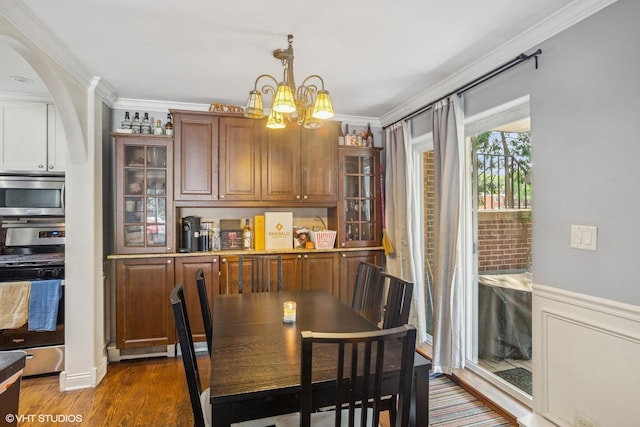 1217 S Old Wilke Rd Unit 101, Arlington Heights, IL 60005 - dining area with a chandelier, crown molding, wood finished floors, and a wainscoted wall