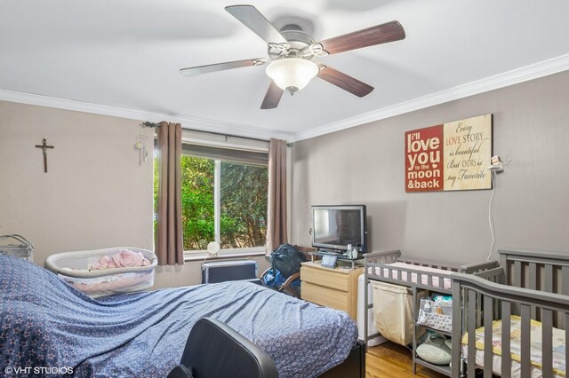 1217 S Old Wilke Rd Unit 101, Arlington Heights, IL 60005 - bedroom featuring ornamental molding, a ceiling fan, and wood finished floors