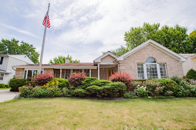 535 Weidner Rd, Buffalo Grove, IL 60089 - single story home with brick siding, a front lawn, and a chimney