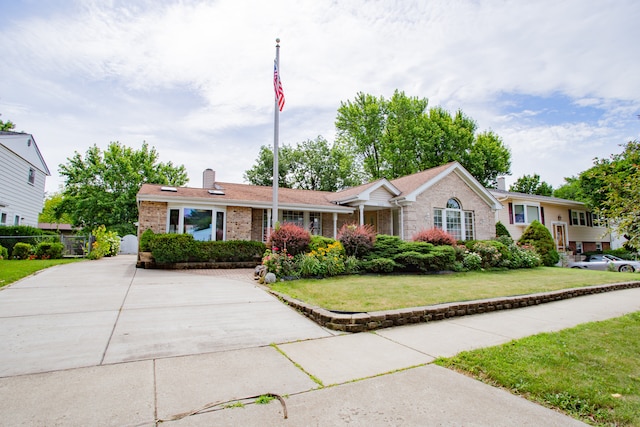 535 Weidner Rd, Buffalo Grove, IL 60089 - ranch-style home with a chimney, brick siding, and concrete driveway