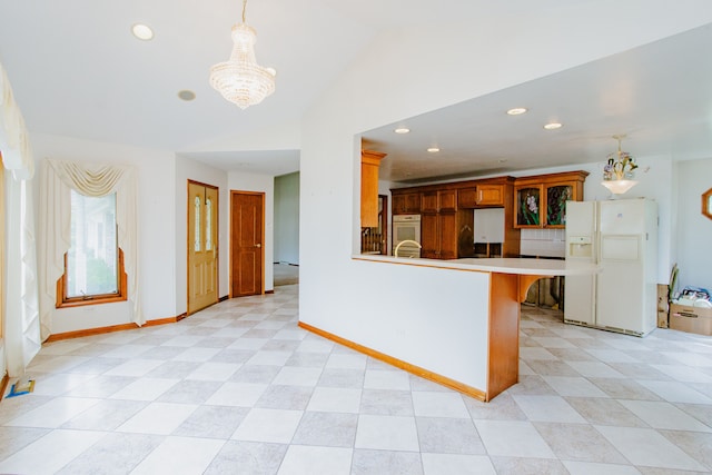 535 Weidner Rd, Buffalo Grove, IL 60089 - kitchen with white appliances, a chandelier, lofted ceiling, a peninsula, and decorative light fixtures