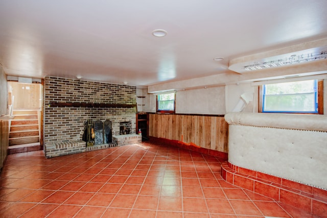 535 Weidner Rd, Buffalo Grove, IL 60089 - basement with wood walls, a brick fireplace, stairway, wainscoting, and tile patterned flooring