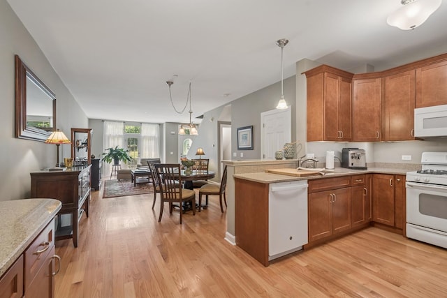8457 Callie Ave, Morton Grove, IL 60053 - kitchen with white appliances, light wood-style flooring, hanging light fixtures, and brown cabinetry