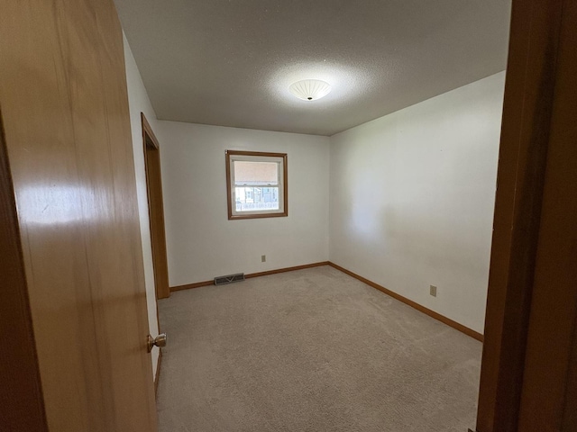 126 N Randolph St, Princeton, IL 61356 - unfurnished bedroom with light carpet and a textured ceiling