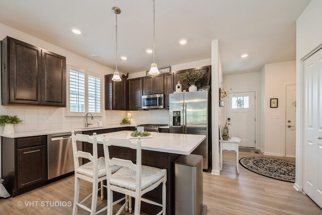321 Mahogany Dr, Algonquin, IL 60102 - kitchen featuring stainless steel appliances, dark brown cabinetry, plenty of natural light, a breakfast bar area, and recessed lighting