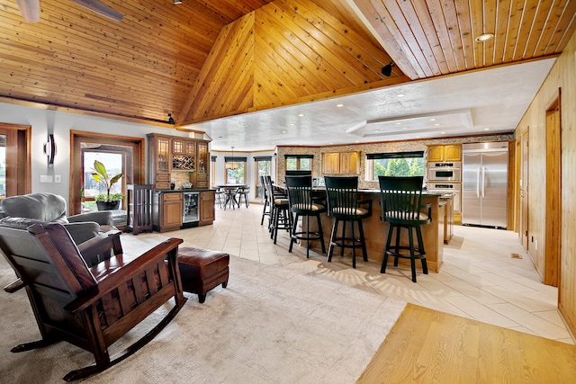 998 N Westshore Blvd, Manteno, IL 60950 - living room with beverage cooler, wood ceiling, light tile patterned flooring, a bar, and a tray ceiling