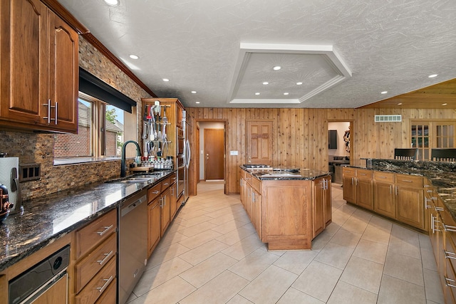 998 N Westshore Blvd, Manteno, IL 60950 - kitchen with dishwasher, recessed lighting, a kitchen island, decorative backsplash, and wooden walls
