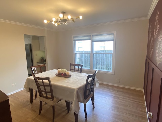 348 Bloomfield Cir, Bloomingdale, IL 60108 - dining space with a chandelier, wood finished floors, and ornamental molding