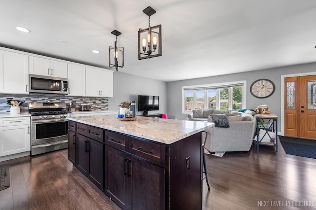 933 Saginaw Ct, Carol Stream, IL 60188 - kitchen with stainless steel appliances, white cabinetry, tasteful backsplash, dark wood-style floors, and recessed lighting