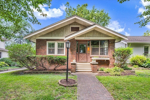 217 S Florence Ave, Bloomington, IL 61701 - view of front facade with a front lawn and brick siding