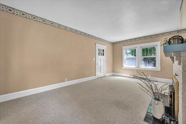 217 S Florence Ave, Bloomington, IL 61701 - carpeted empty room with baseboards and a fireplace