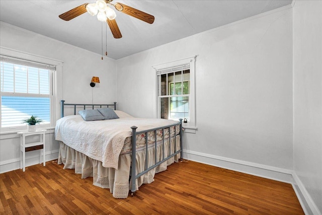 217 S Florence Ave, Bloomington, IL 61701 - bedroom with multiple windows, wood finished floors, ornamental molding, and ceiling fan