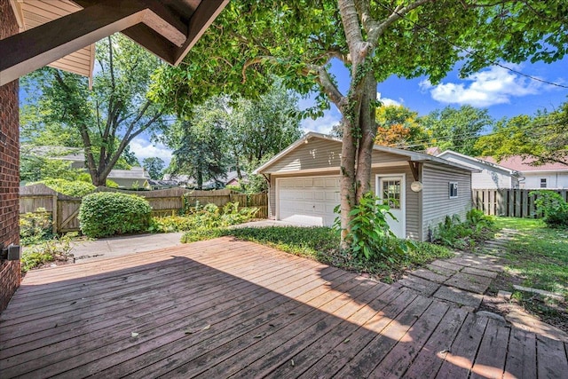 217 S Florence Ave, Bloomington, IL 61701 - wooden terrace featuring a fenced backyard, an outbuilding, and a garage