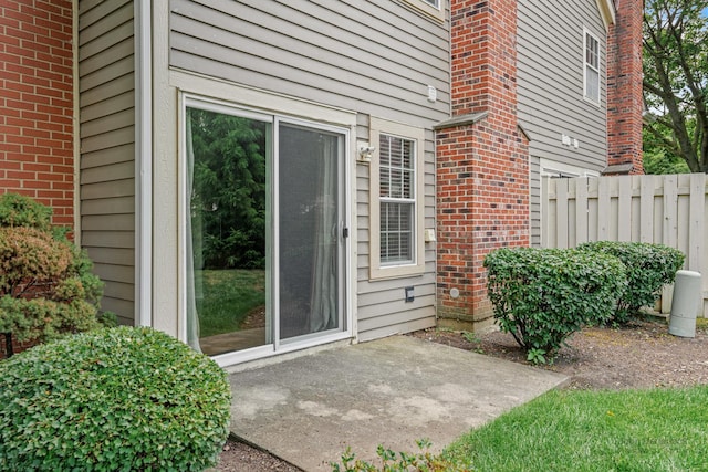 223 New Bridge Ct, Palatine, IL 60067 - view of exterior entry with brick siding and a patio