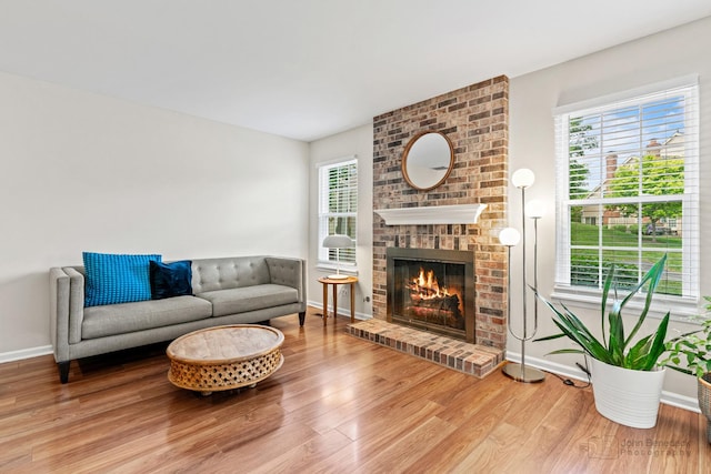 223 New Bridge Ct, Palatine, IL 60067 - living room featuring wood finished floors, a brick fireplace, and plenty of natural light