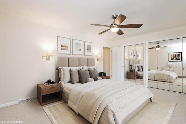 3231 Central St, Evanston, IL 60201 - bedroom featuring two closets, light carpet, and a ceiling fan