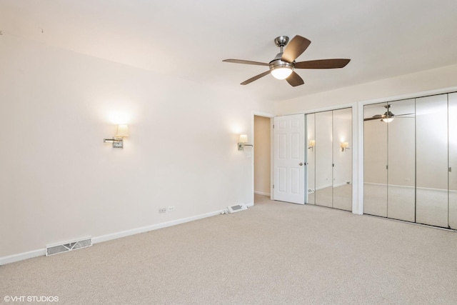 3231 Central St, Evanston, IL 60201 - unfurnished bedroom featuring multiple closets, carpet floors, and a ceiling fan