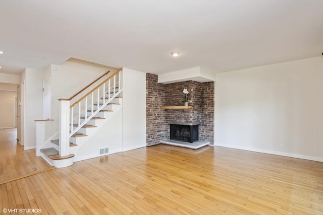 3231 Central St, Evanston, IL 60201 - unfurnished living room with wood-type flooring, stairway, recessed lighting, and a fireplace