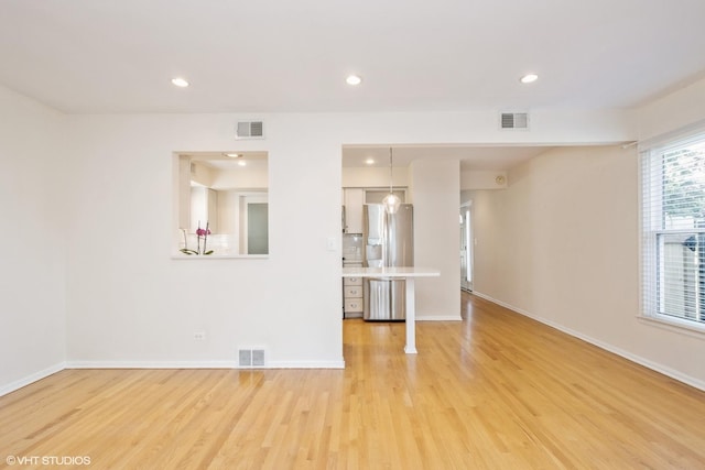 3231 Central St, Evanston, IL 60201 - unfurnished living room with light wood-style flooring and recessed lighting