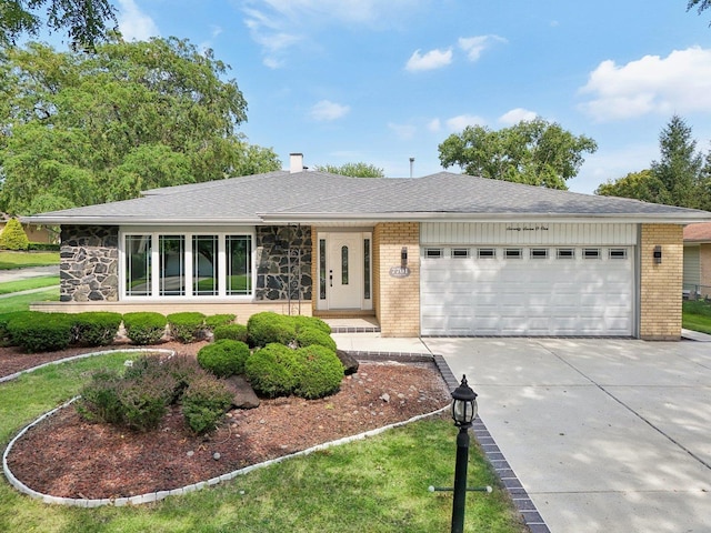 7701 Sawyer Rd, Darien, IL 60561 - view of front of property with brick siding, driveway, an attached garage, a chimney, and stone siding