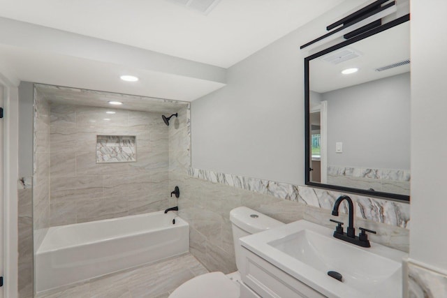 7701 Sawyer Rd, Darien, IL 60561 - bathroom featuring washtub / shower combination, vanity, tile walls, recessed lighting, and a wainscoted wall
