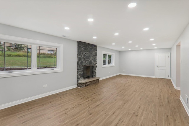 7701 Sawyer Rd, Darien, IL 60561 - unfurnished living room featuring light wood-style floors, a stone fireplace, and recessed lighting