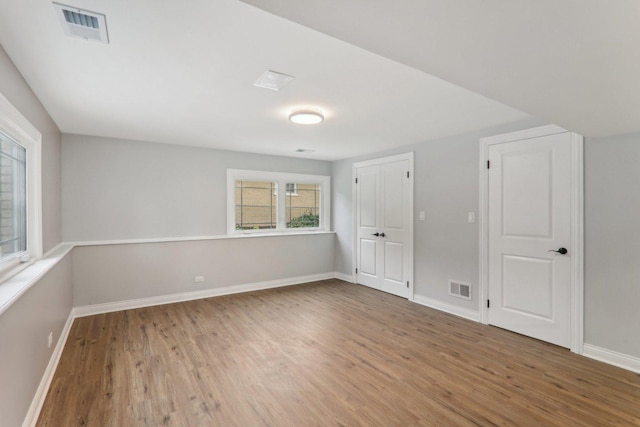 7701 Sawyer Rd, Darien, IL 60561 - unfurnished bedroom featuring wood finished floors and baseboards