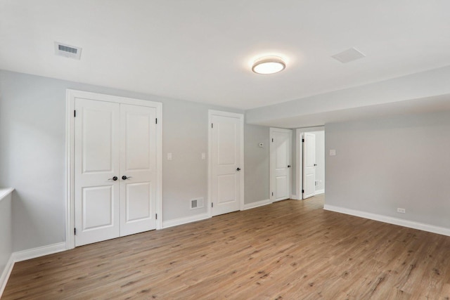 7701 Sawyer Rd, Darien, IL 60561 - unfurnished bedroom with light wood-style flooring