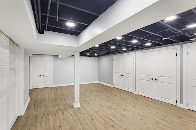 7701 Sawyer Rd, Darien, IL 60561 - finished basement featuring light wood-style flooring and baseboards