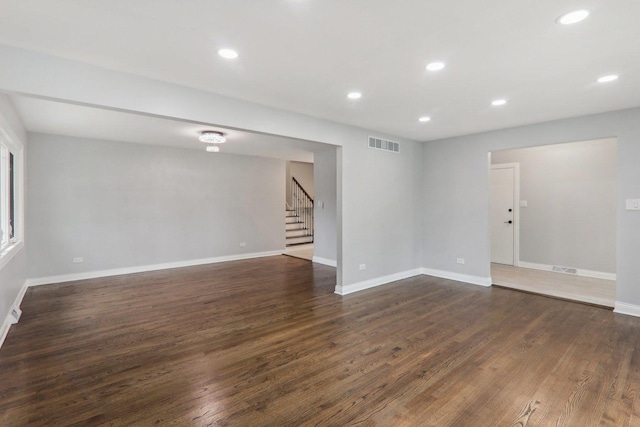 7701 Sawyer Rd, Darien, IL 60561 - spare room with stairway, dark wood-style floors, and recessed lighting