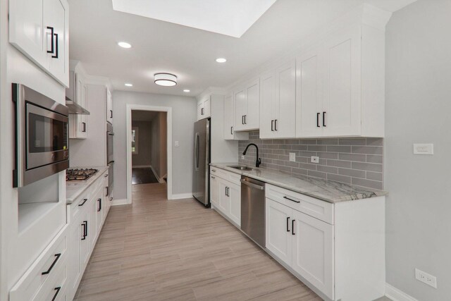 7701 Sawyer Rd, Darien, IL 60561 - kitchen with stainless steel appliances, white cabinets, decorative backsplash, recessed lighting, and light stone countertops