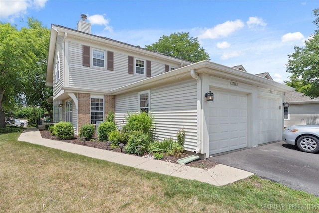 27W414 Melrose Ln, Winfield, IL 60190 - view of front of house with a chimney, a front yard, a garage, driveway, and brick siding