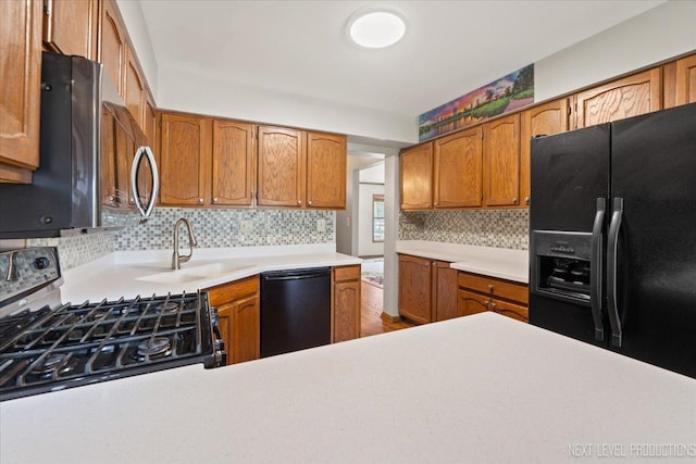 27W414 Melrose Ln, Winfield, IL 60190 - kitchen featuring black appliances, decorative backsplash, light countertops, and brown cabinets