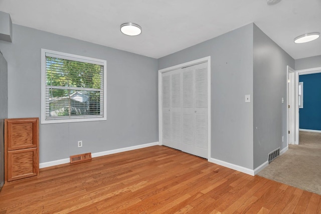 25034 S Center St, Channahon, IL 60410 - unfurnished bedroom with light wood finished floors and a closet
